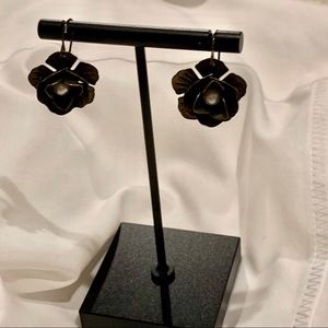 Metal flower earring with a pearl on the middle.